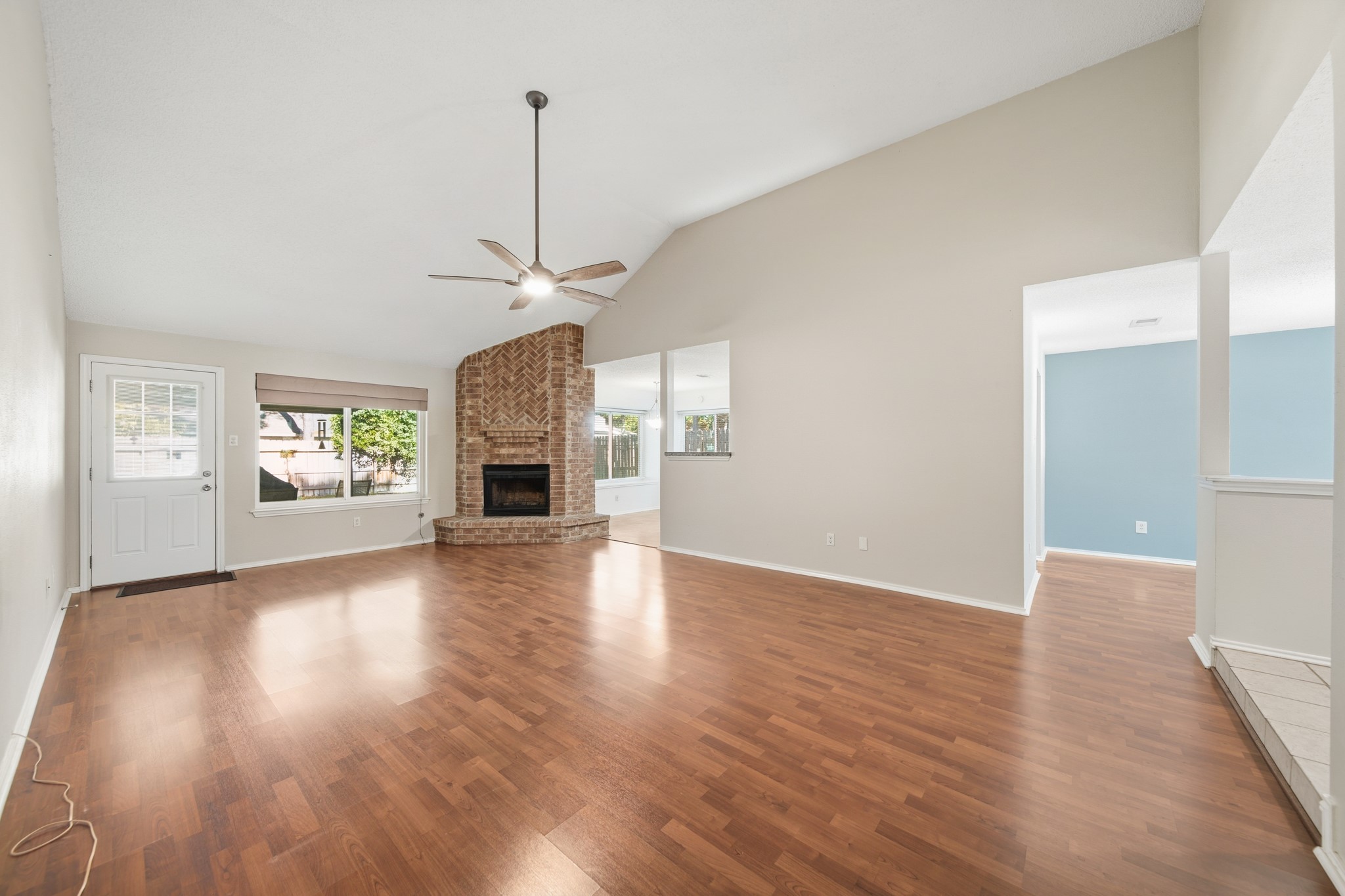 9518 Dundalk Street Spring, TX 77379 - Photo 9 of 46 an empty room with wooden floor fireplace and windows