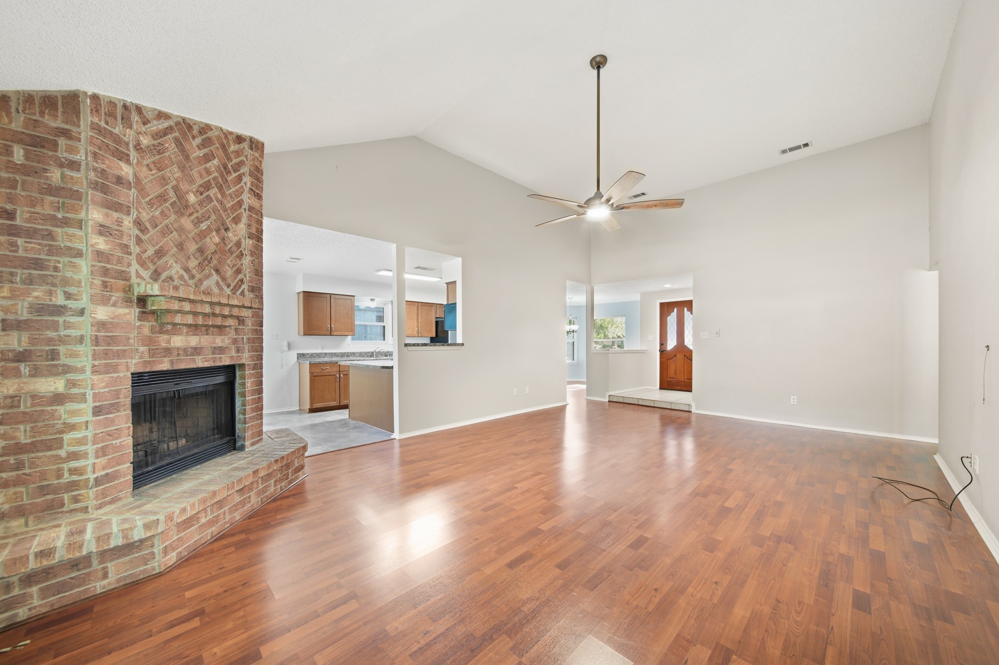 9518 Dundalk Street Spring, TX 77379 - Photo 10 of 46 a view of empty room with wooden floor and fireplace