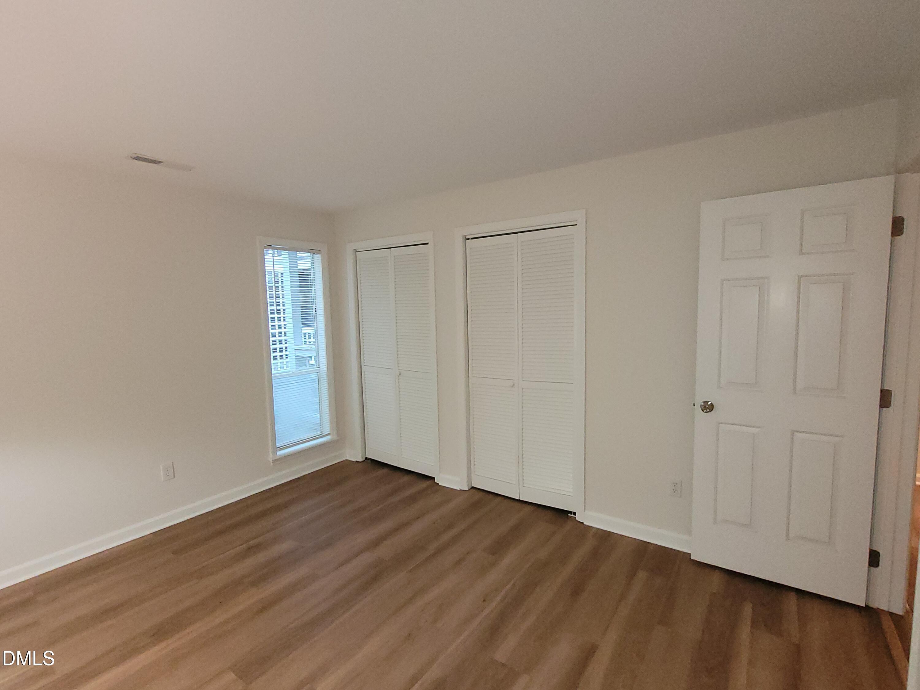 4651 Timbermill Court, Unit 103 Raleigh, NC 27612 - Photo 23 of 40 Wood-finish flooring, white walls, and a window with blinds
