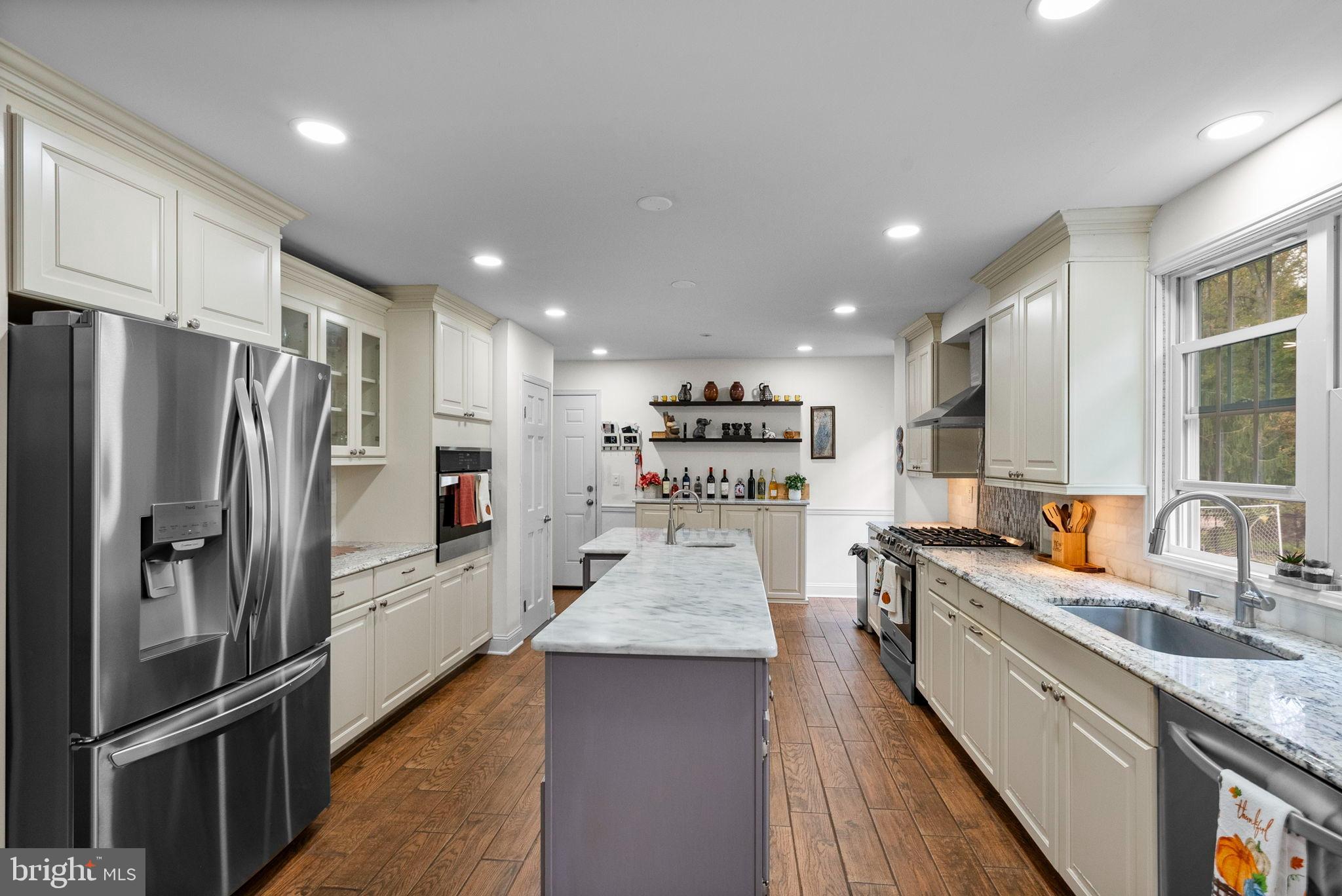 40 Doe Drive Hamilton, NJ 08620 - Photo 15 of 62 a large kitchen with stainless steel appliances granite countertop a sink refrigerator and cabinets