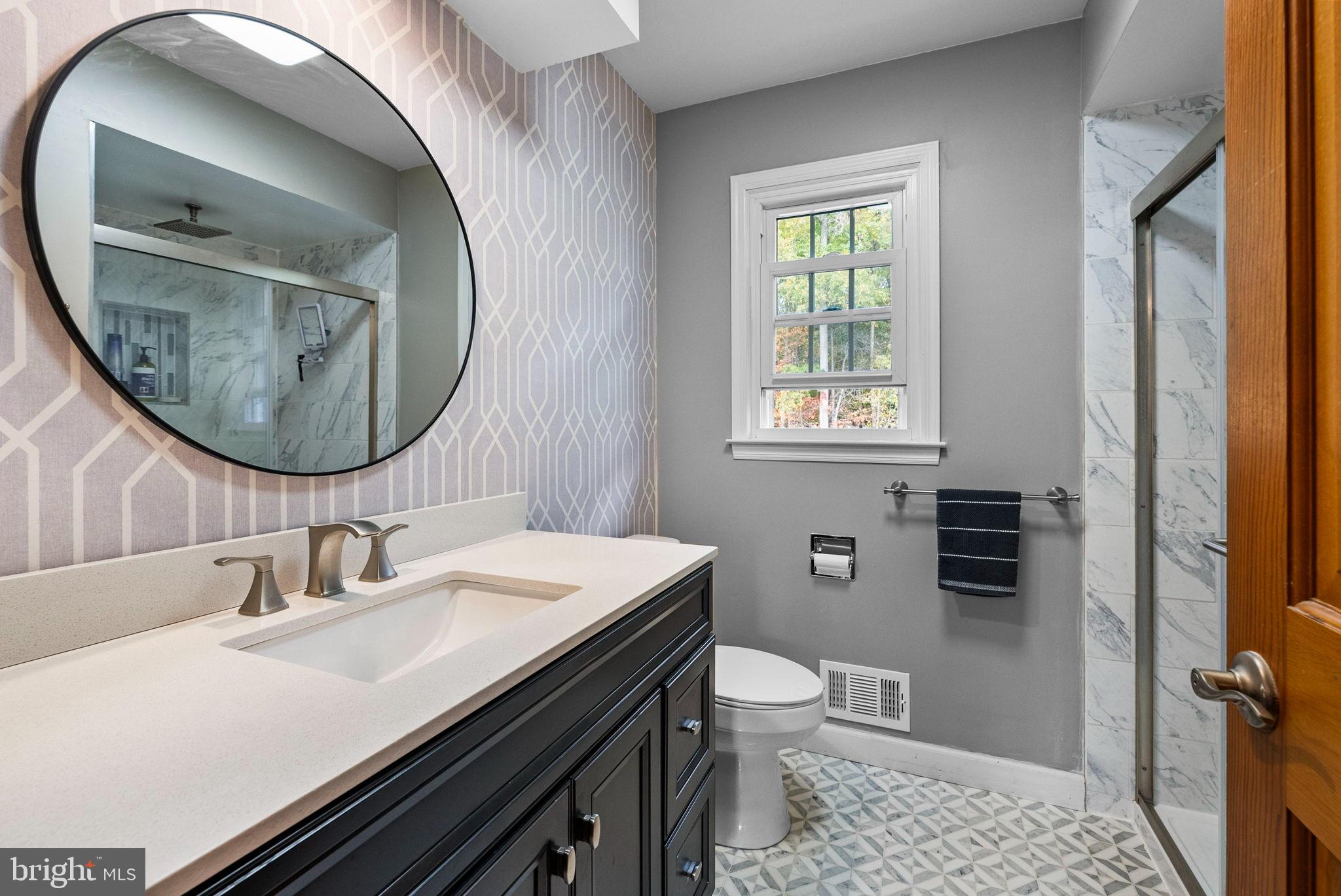 40 Doe Drive Hamilton, NJ 08620 - Photo 40 of 62 a bathroom with a sink a toilet and mirror