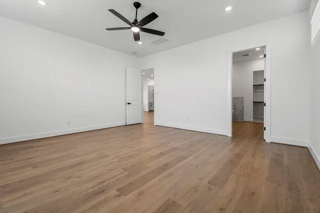 a white bath tub sitting next to a shower