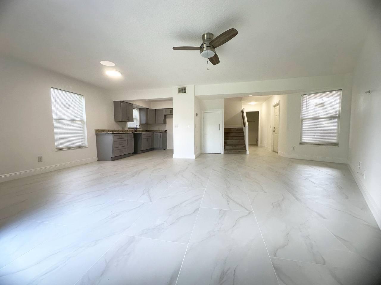1033 Goldenrod Road Wellington, FL 33414 - Photo 3 of 8 a view of a livingroom with a staircase