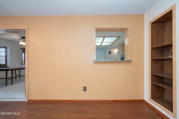 a view of a room with wooden floor and cabinet