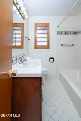 a bathroom with a sink a mirror and a bathtub