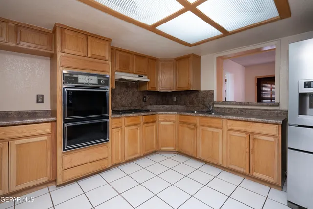 a kitchen with granite countertop stainless steel appliances and cabinets
