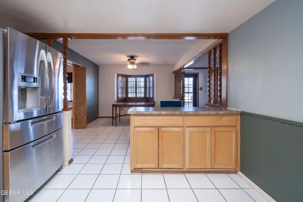 a kitchen with stainless steel appliances granite countertop a refrigerator a stove and a sink