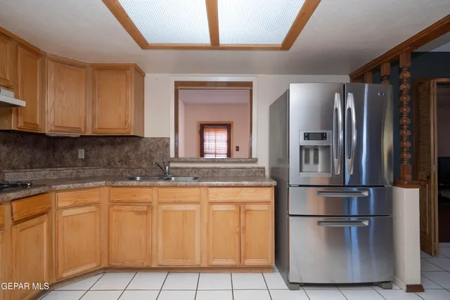 a kitchen with cabinets and stainless steel appliances