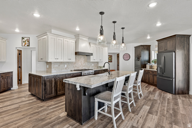 3311 West Allard Summit, UT 84772 - Photo 23 of 97 Contemporary kitchen featuring an expansive center island with seating, a gas range, and a full-size refrigerator