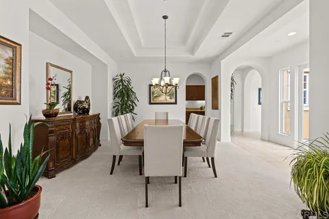 a large kitchen with a sink counter top space a stove and cabinets