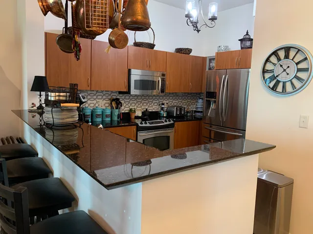 a kitchen with stainless steel appliances granite countertop a sink and cabinets