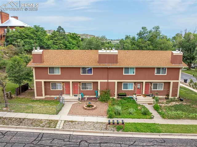 front view of a brick house next to a yard