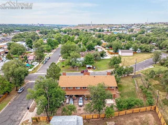 an aerial view of residential houses with outdoor space and river