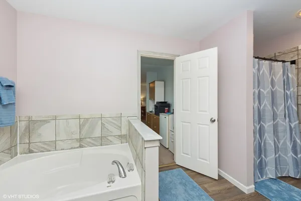 a bathroom with bathtub and shower