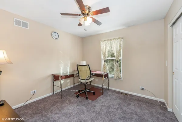 a view of a workspace with furniture and a window