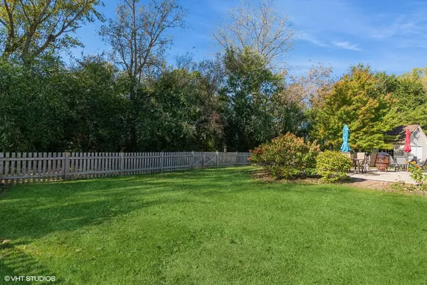 a view of a yard and a fence