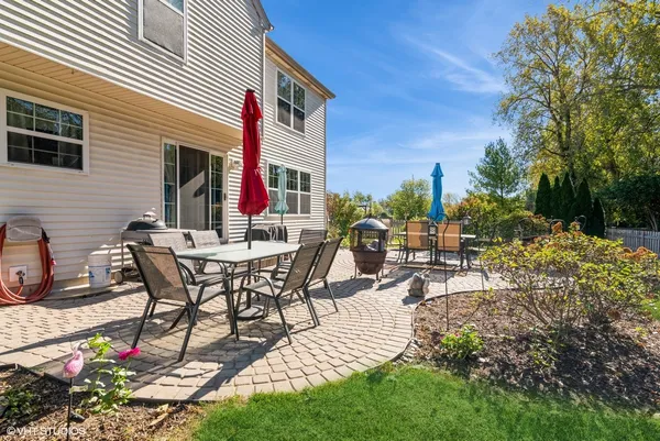 a view of a patio with table and chairs and potted plants