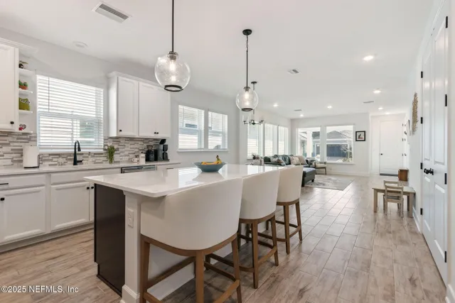 a living room with furniture a window and a chandelier