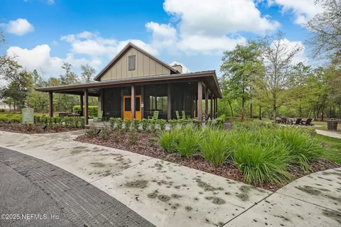 a view of a swimming pool with a table and chairs under an umbrella