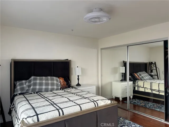 a bedroom with a bed and a mirror