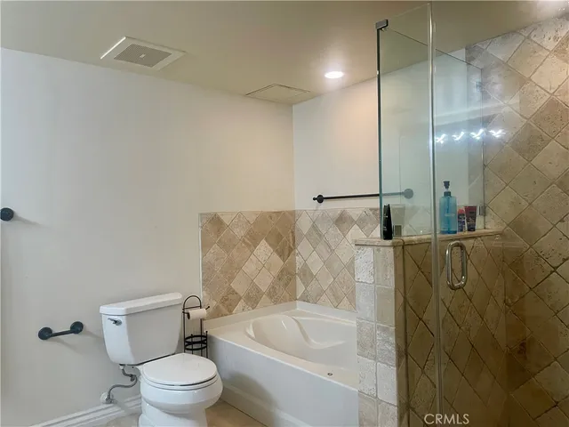 a bathroom with a bathtub and a toilet