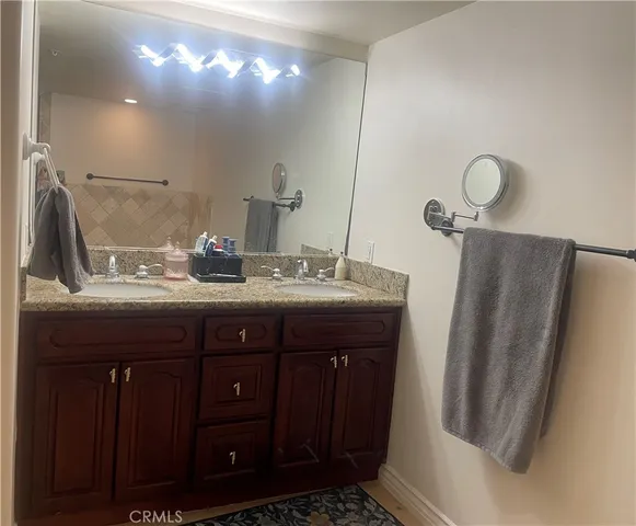 a bathroom with a sink a vanity and a mirror