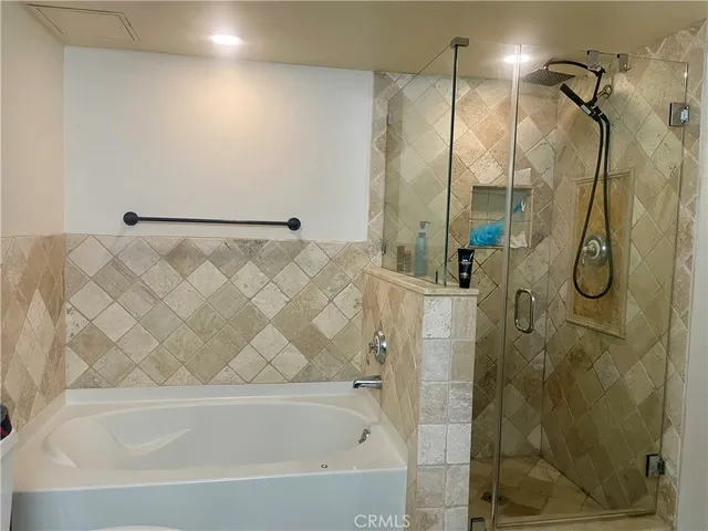 a bathroom with a bath tub and shower