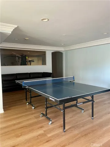 a room with furniture pool table and wooden floor