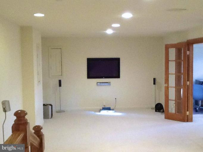 8243 Spring Branch Court Laurel, MD 20723 - Photo 2 of 5 a living room with a flat screen tv and a lamp