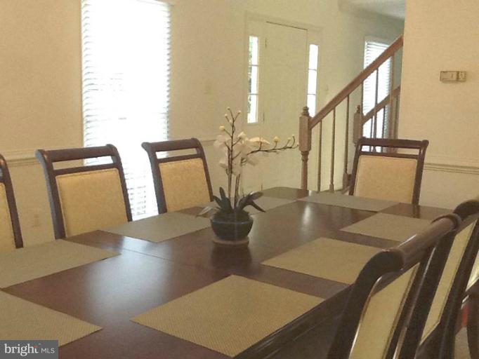 8243 Spring Branch Court Laurel, MD 20723 - Photo 3 of 5 a view of a dining room with furniture and wooden floor