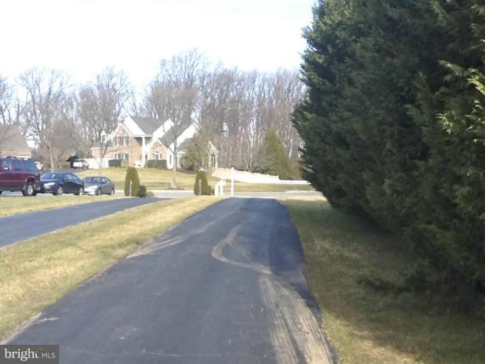 8243 Spring Branch Court Laurel, MD 20723 - Photo 4 of 5 a view of a house with a yard and tree s