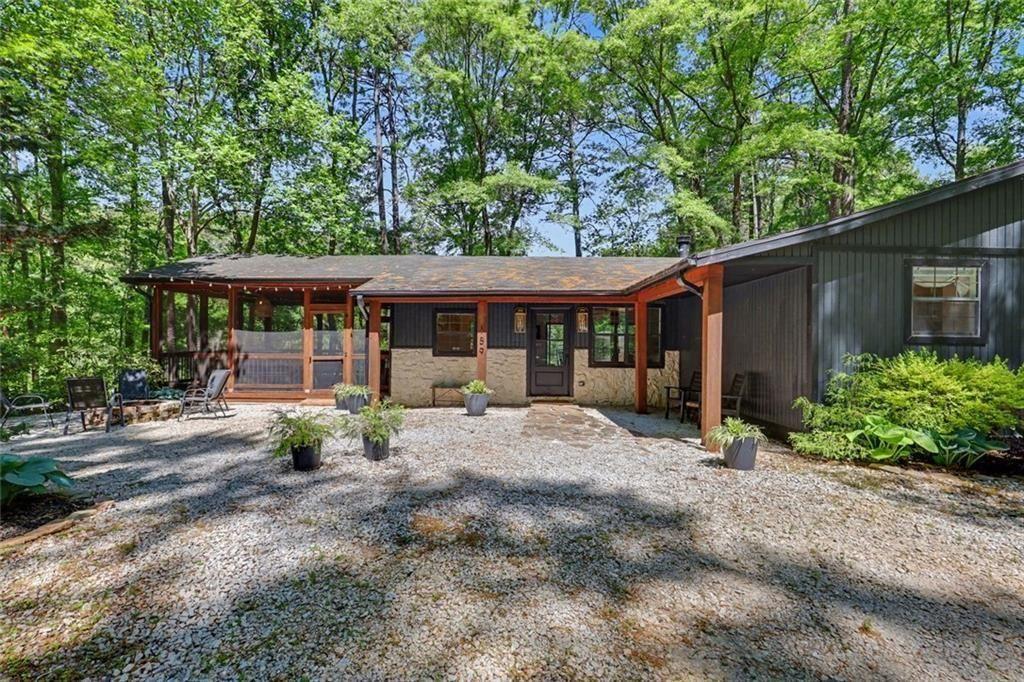 a patio with a table and chairs under an umbrella