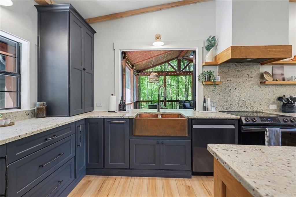 159 Manor Oak Trail Toccoa, GA 30577 - Photo 19 of 68 a kitchen with a sink and wooden cabinets