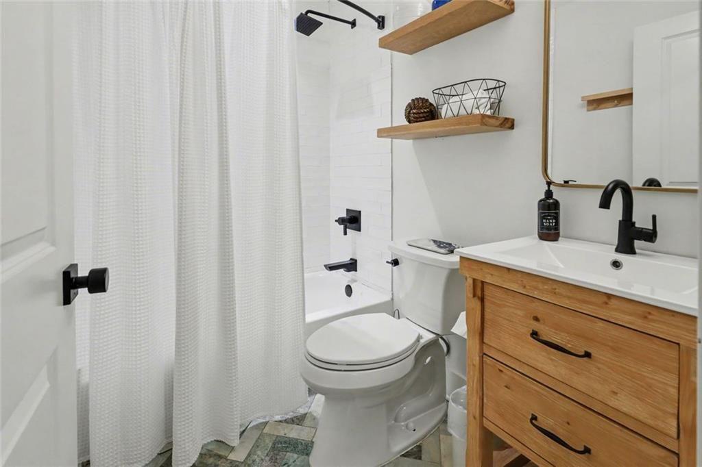 159 Manor Oak Trail Toccoa, GA 30577 - Photo 41 of 68 a bathroom with a sink a toilet and shower curtain