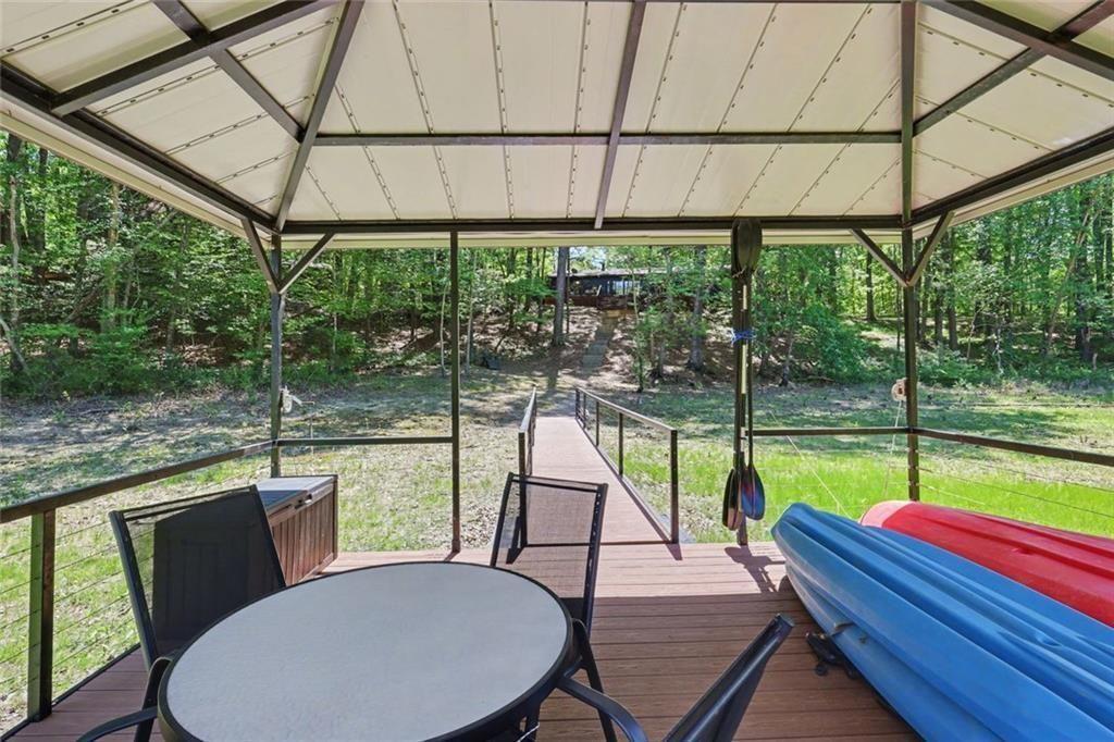 159 Manor Oak Trail Toccoa, GA 30577 - Photo 63 of 68 a view of a patio with table and chairs under an umbrella