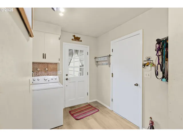 a view of kitchen with refrigerator and cabinets