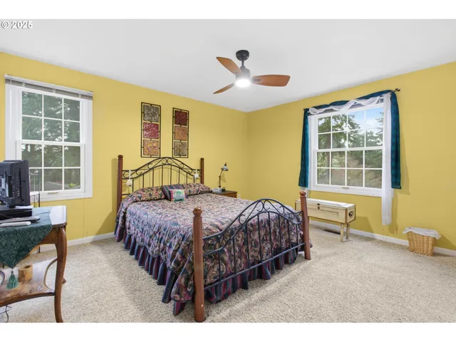 a bedroom with a bed chair and window