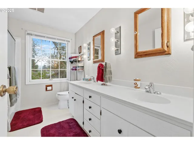 a bathroom with a sink mirror and window