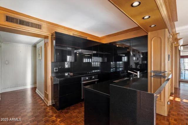 a kitchen with stainless steel appliances granite countertop a refrigerator and a stove