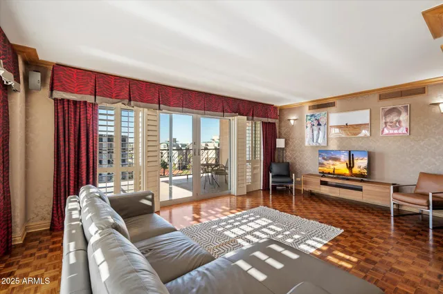 a living room with furniture and a floor to ceiling window