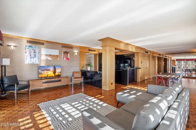 a living room with furniture a dining table and chairs with wooden floor