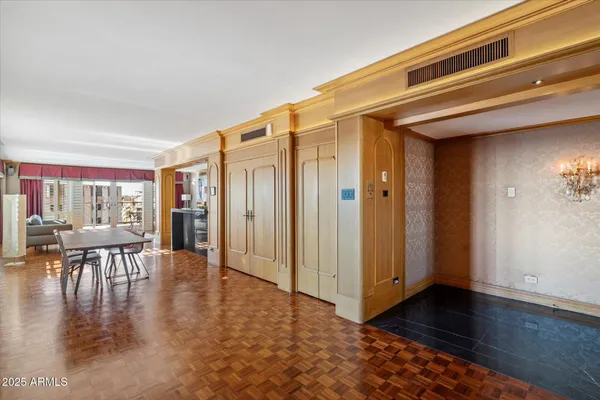 an entryway space with furniture and wooden floor