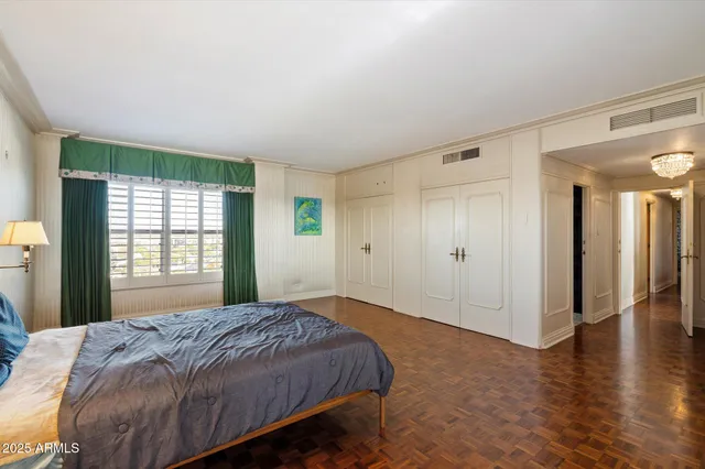 a spacious bedroom with a bed and a window