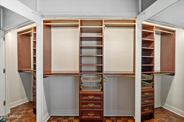 a view of walk in closet with empty racks
