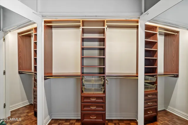 a view of walk in closet with empty racks