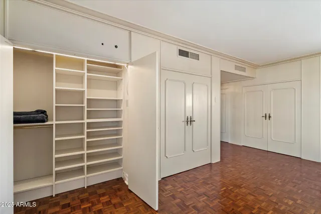 a view of closet area with empty racks