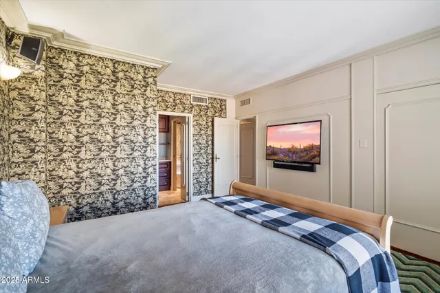 a bed room with a bed and a flat screen tv