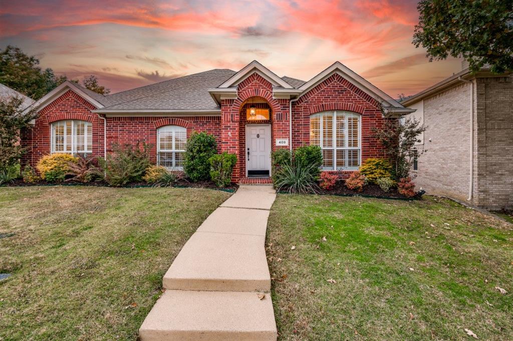 409 Ridge Meade Drive Lewisville, TX 75067 - Photo 1 of 1 a front view of a house with garden