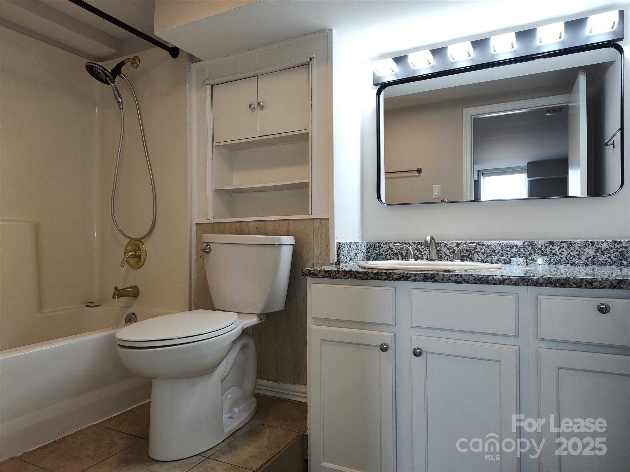 340 Hollis Road Charlotte, NC 28209 - Photo 19 of 21 a bathroom with a toilet sink and mirror