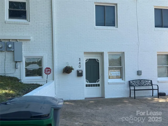 a view of front door of house and car parked